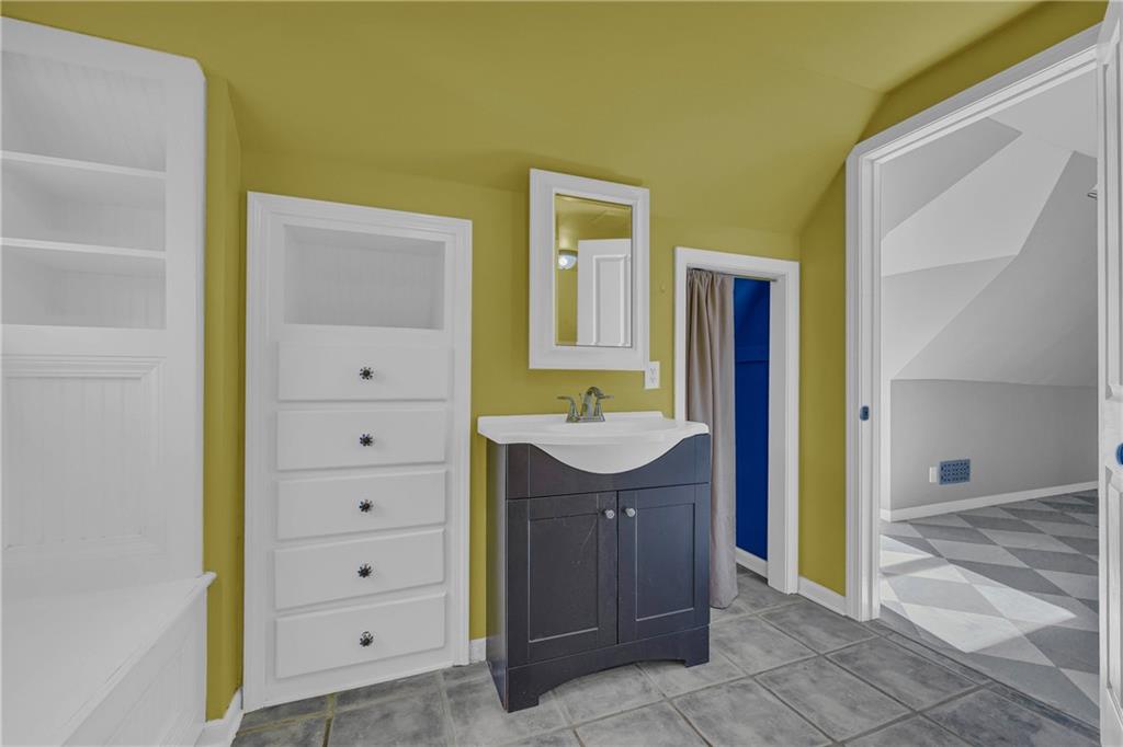 5921 Bostwick Road Bishop, GA 30621 - Photo 46 of 65 a bathroom with a sink a mirror and a shower