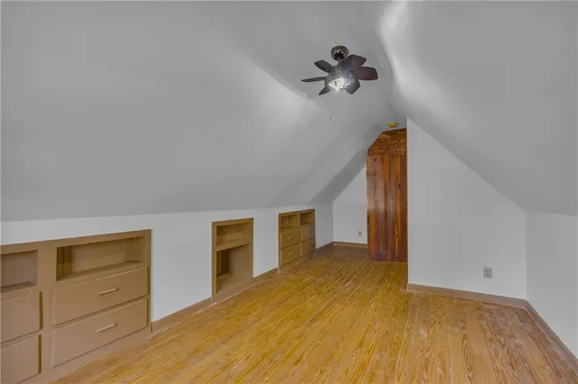 a view of a house with a yard and large tree