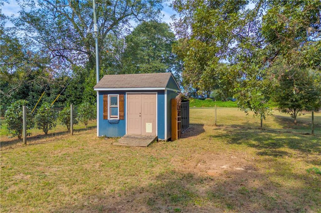 5921 Bostwick Road Bishop, GA 30621 - Photo 57 of 65 a view of a house with a yard and large tree