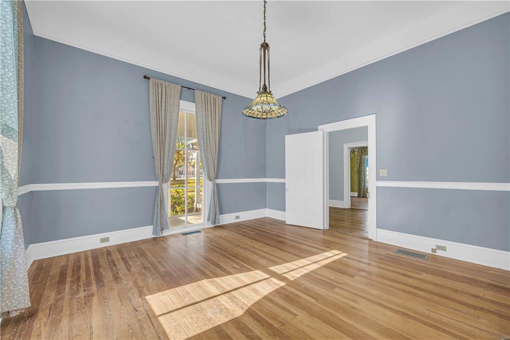 5921 Bostwick Road Bishop, GA 30621 - Photo 10 of 65 a view of an empty room with window and wooden floor