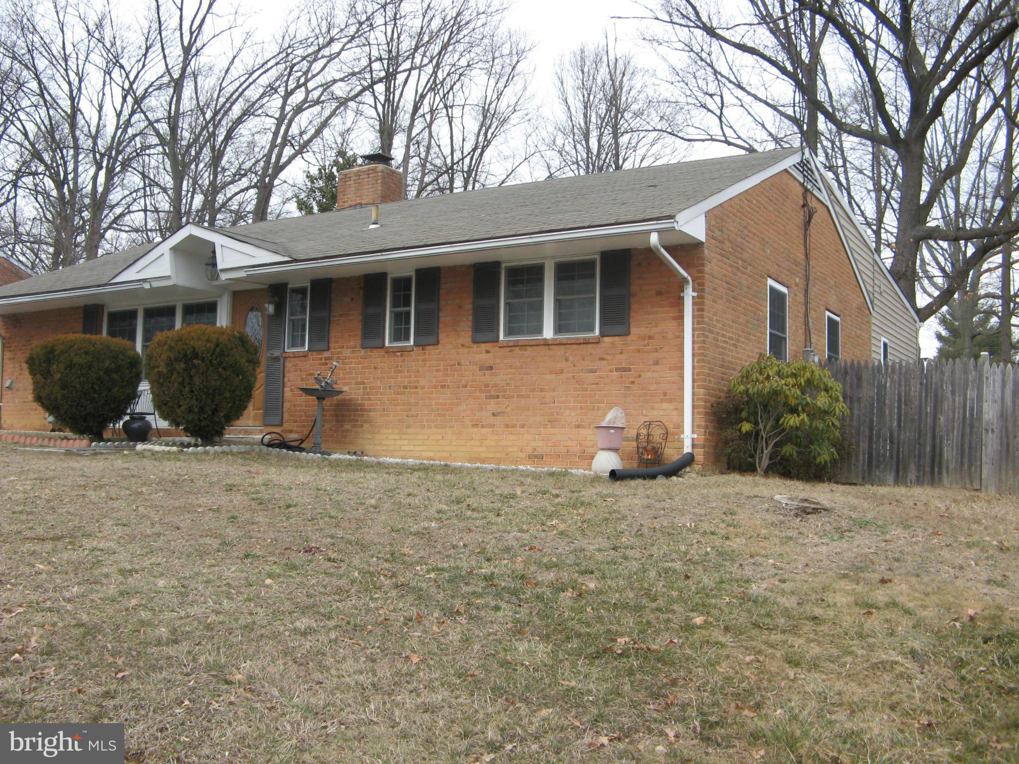 7302 Old Keene Mill Road Springfield, VA 22150 - Photo 1 of 28 a front view of a house with a yard and garage