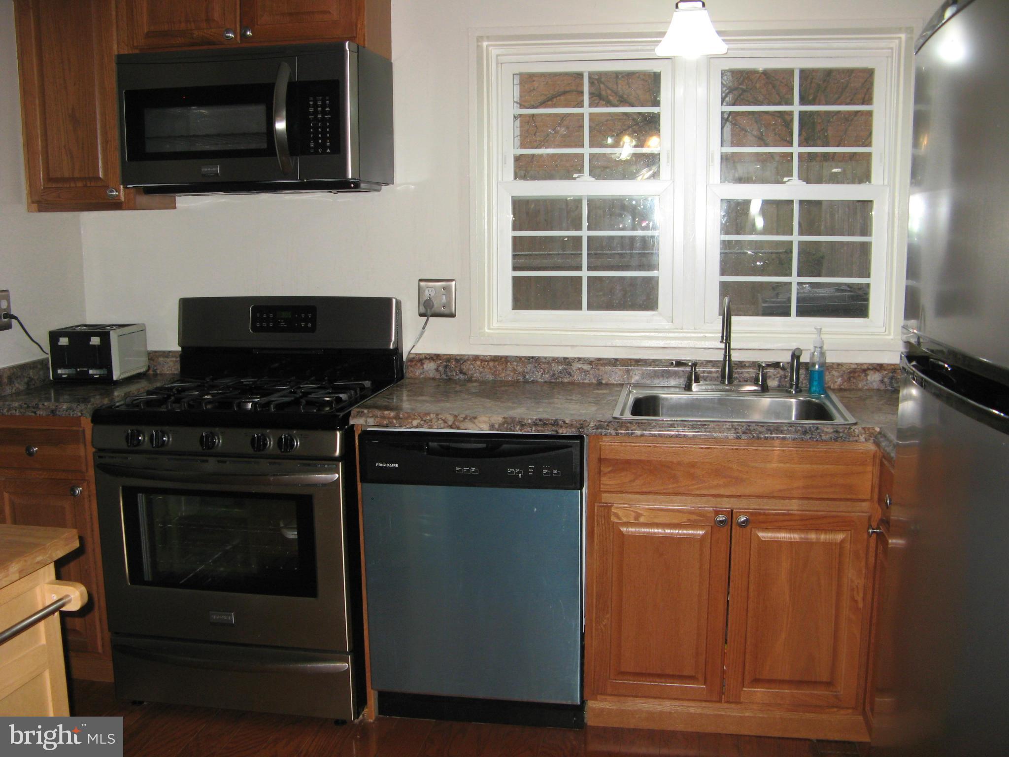 7302 Old Keene Mill Road Springfield, VA 22150 - Photo 11 of 28 a kitchen with granite countertop a stove and a microwave