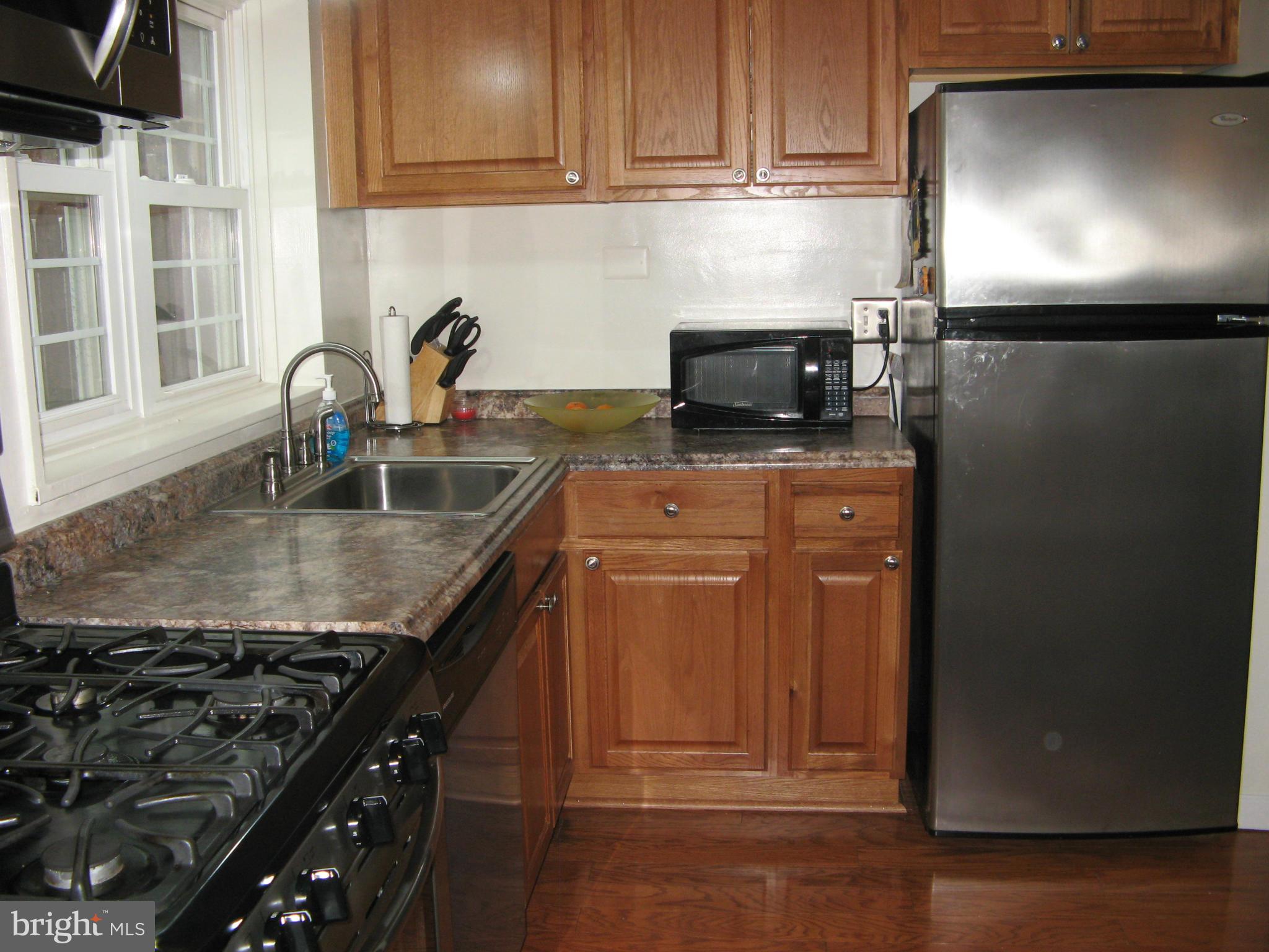 7302 Old Keene Mill Road Springfield, VA 22150 - Photo 12 of 28 a kitchen with granite countertop a sink stove and cabinets