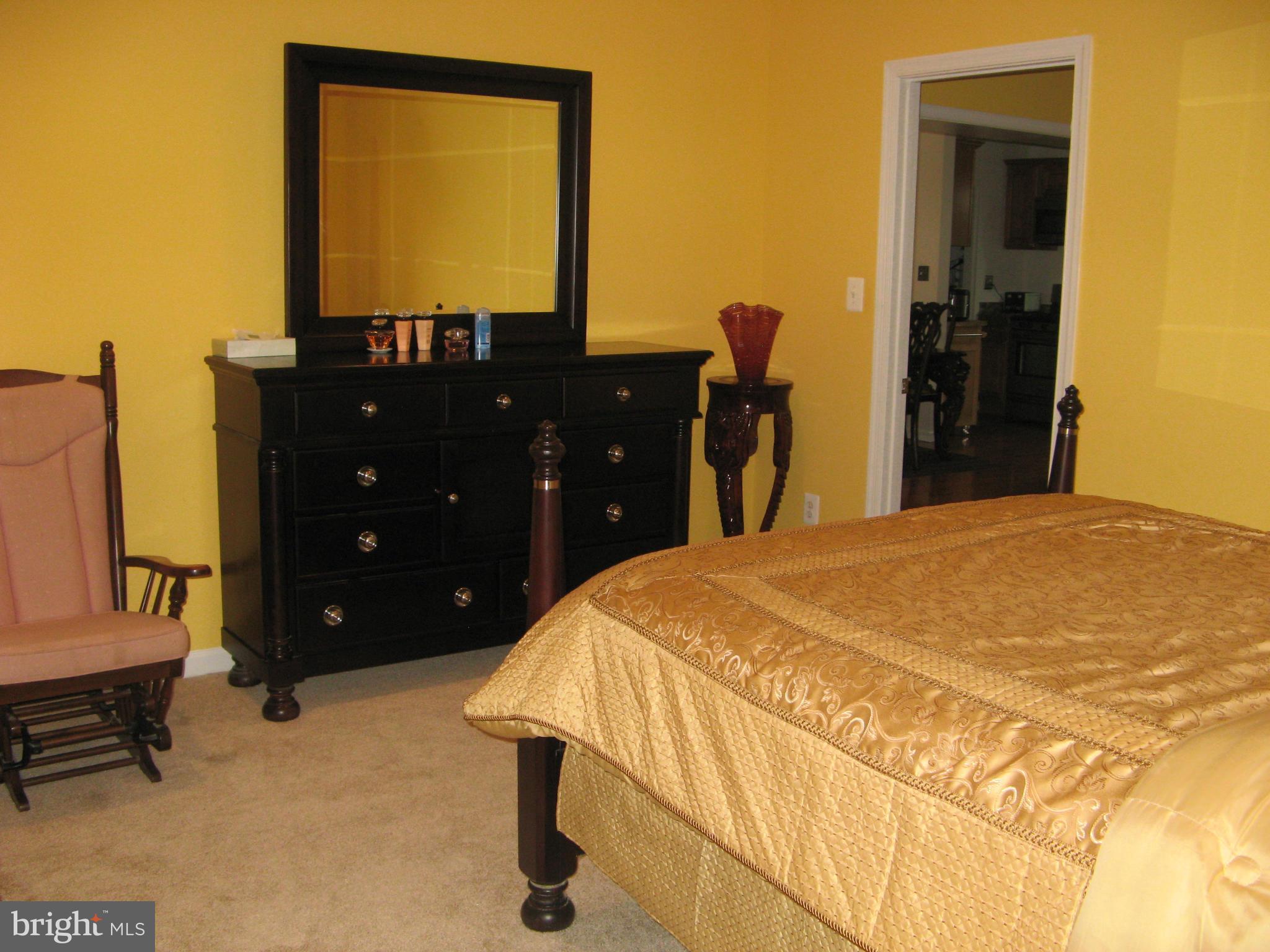 7302 Old Keene Mill Road Springfield, VA 22150 - Photo 18 of 28 a bedroom with a bed and a dresser