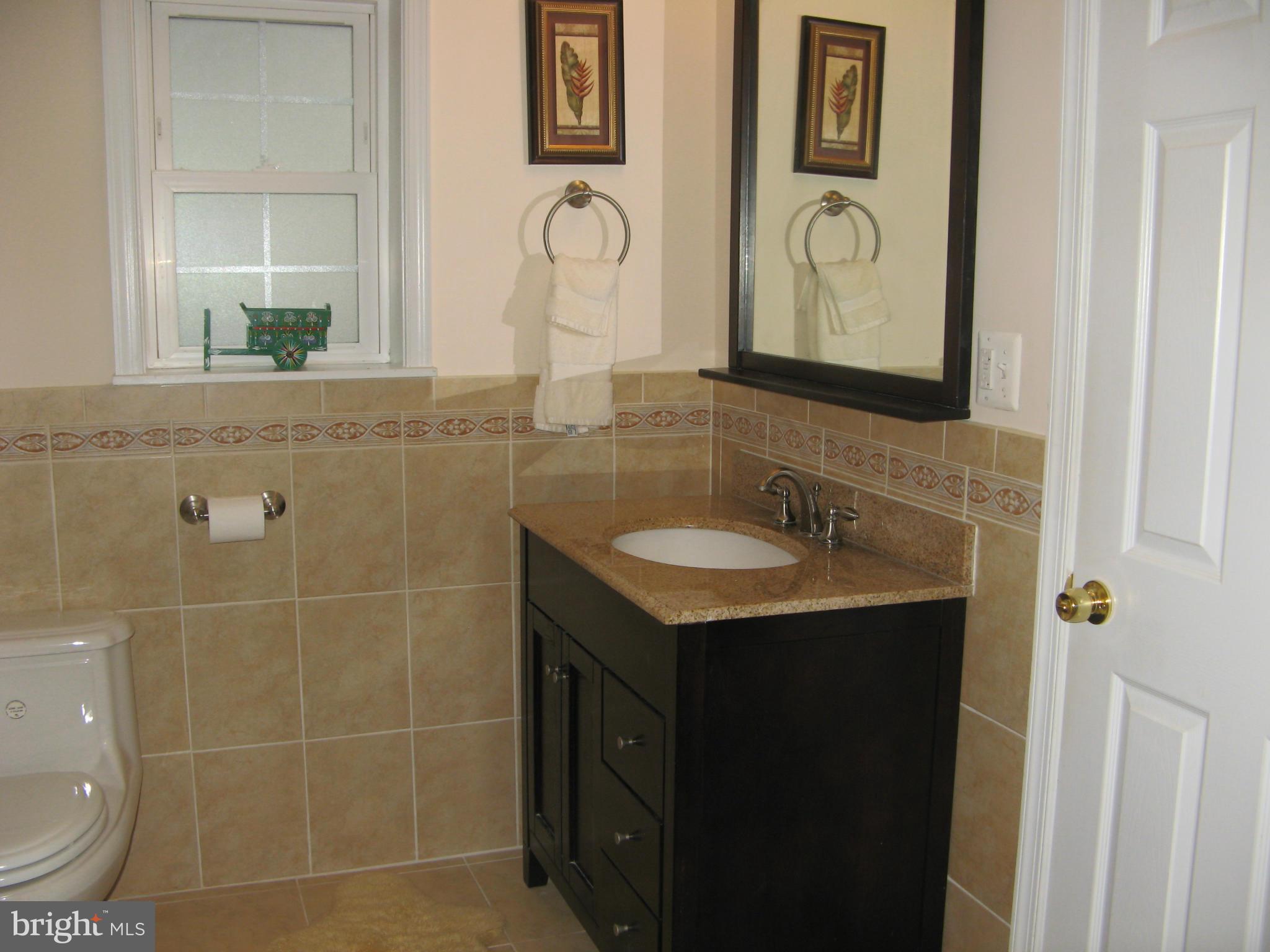 7302 Old Keene Mill Road Springfield, VA 22150 - Photo 19 of 28 a bathroom with a granite countertop sink and a mirror