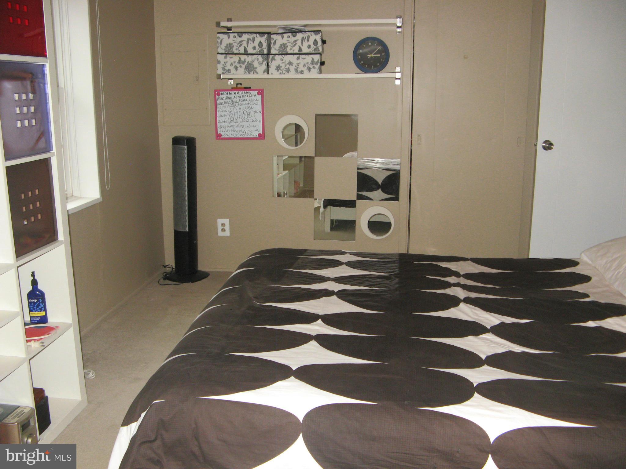 7302 Old Keene Mill Road Springfield, VA 22150 - Photo 21 of 28 a bedroom with a bed and cabinets