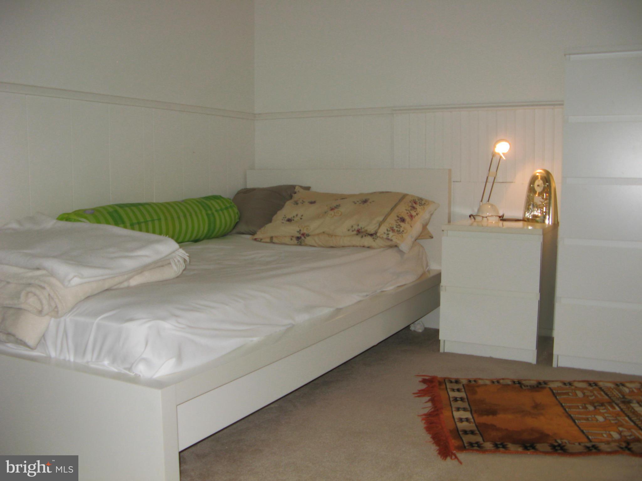7302 Old Keene Mill Road Springfield, VA 22150 - Photo 23 of 28 a bedroom with a bed and a couch