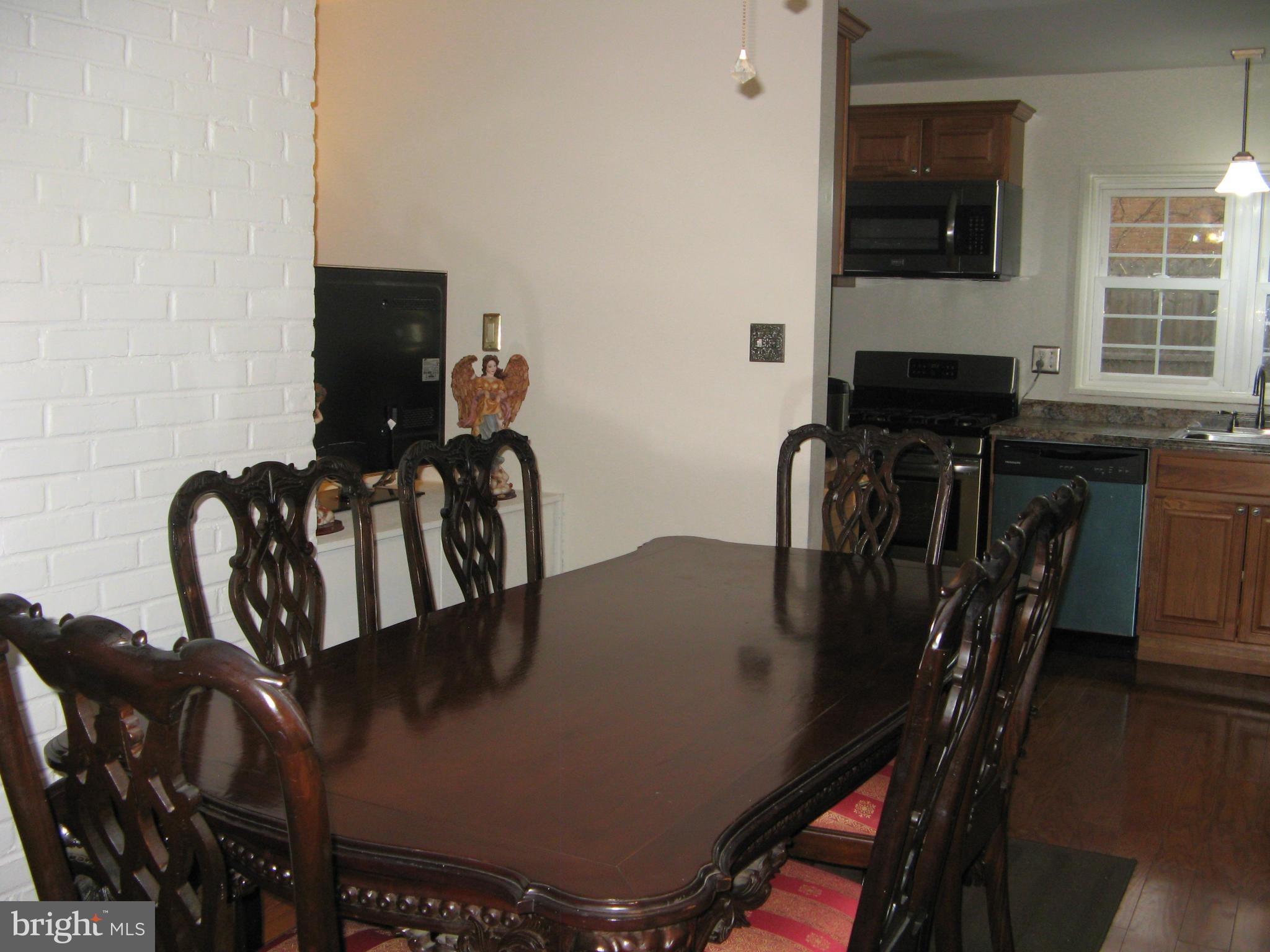 7302 Old Keene Mill Road Springfield, VA 22150 - Photo 8 of 28 a view of a dining room with furniture and wooden floor
