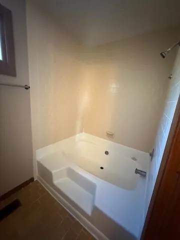 a view of a livingroom with a ceiling fan and wooden floor