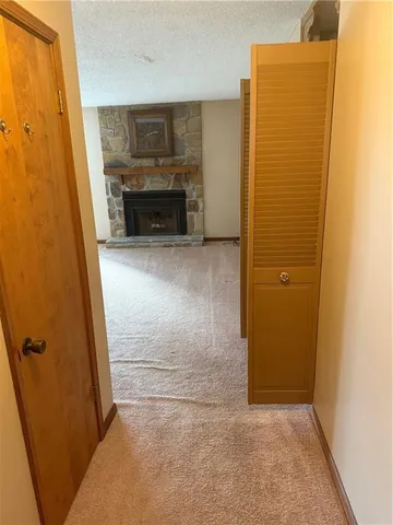 an empty room with fireplace and a window