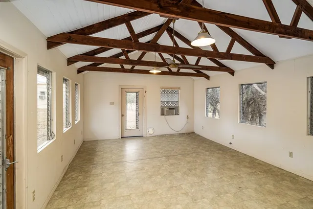 a view of a room with a window and furniture