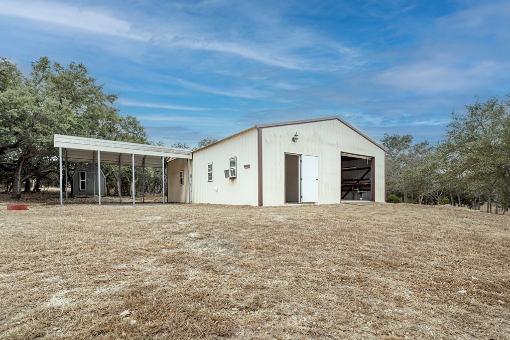 110 Sierra Road Kerrville, TX 78028 - Photo 19 of 31 a front view of a house with a yard and garage
