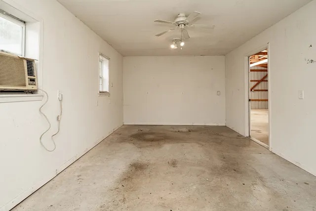 a view of a room with window and a ceiling fan
