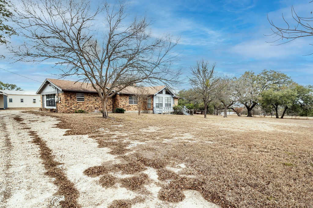 110 Sierra Road Kerrville, TX 78028 - Photo 28 of 31 a view of white house with a yard covered in snow