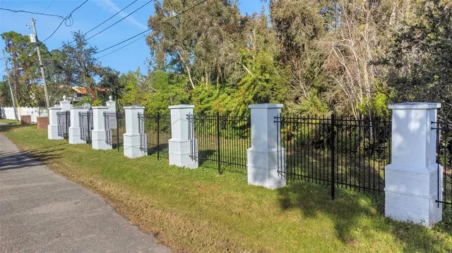 a view of a backyard with large trees