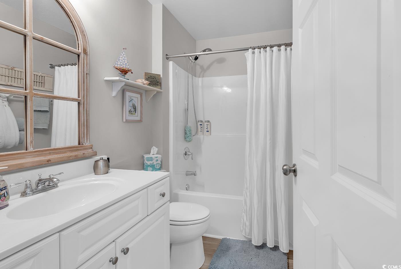 117 Butkus Drive, Unit 2 Myrtle Beach, SC 29588 - Photo 26 of 39 Full bathroom with shower / bathtub combination with curtain, vanity, and dark wood finished floors