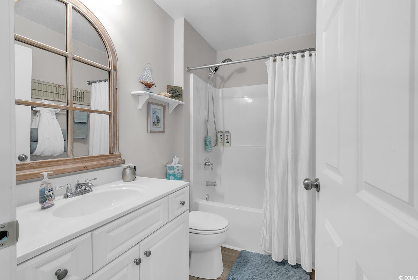 117 Butkus Drive, Unit 2 Myrtle Beach, SC 29588 - Photo 27 of 39 Full bathroom with vanity, shower / bath combo with shower curtain, and dark wood-type flooring