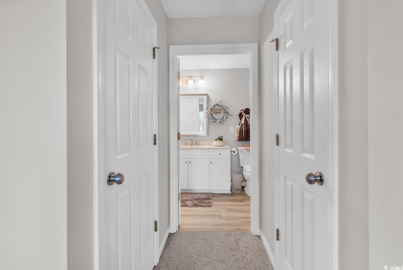 117 Butkus Drive, Unit 2 Myrtle Beach, SC 29588 - Photo 28 of 39 Corridor with light colored carpet and a sink