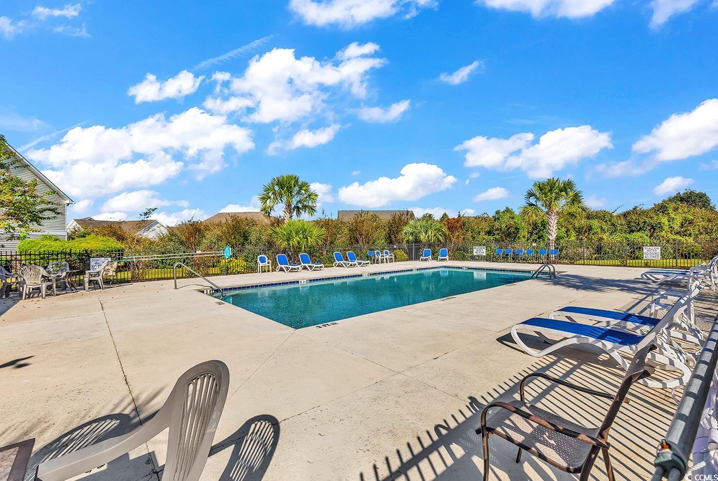117 Butkus Drive, Unit 2 Myrtle Beach, SC 29588 - Photo 33 of 39 Community pool featuring a patio
