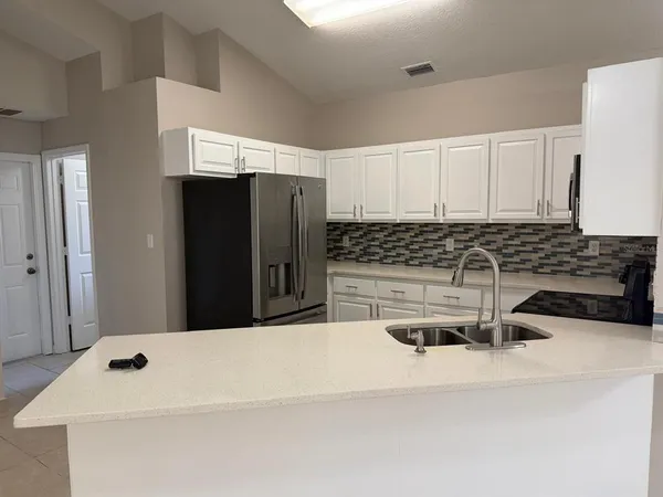 a kitchen with a sink and a refrigerator