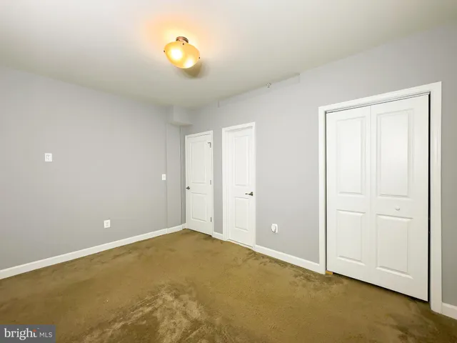 a spacious bathroom with a granite countertop double vanity sink a mirror and a bathtub