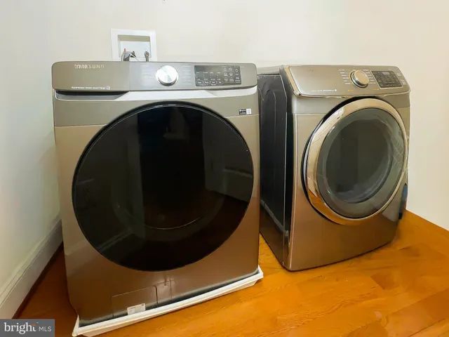 a room with a white bed and dresser