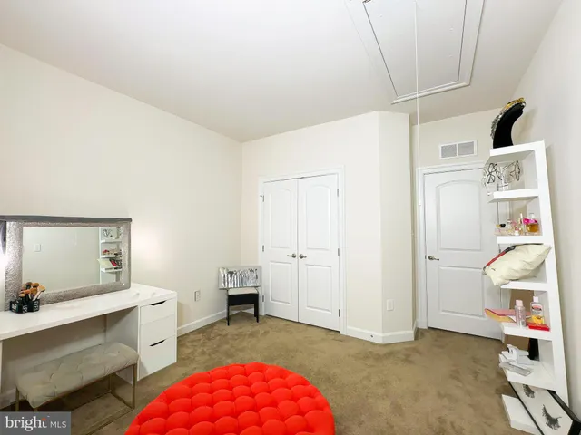 a living room with table and chairs with wooden floor