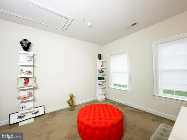 a living room with furniture and a table with wooden floor
