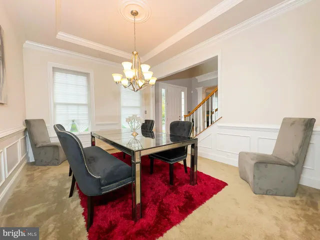 a view of a dining room with furniture and chandelier