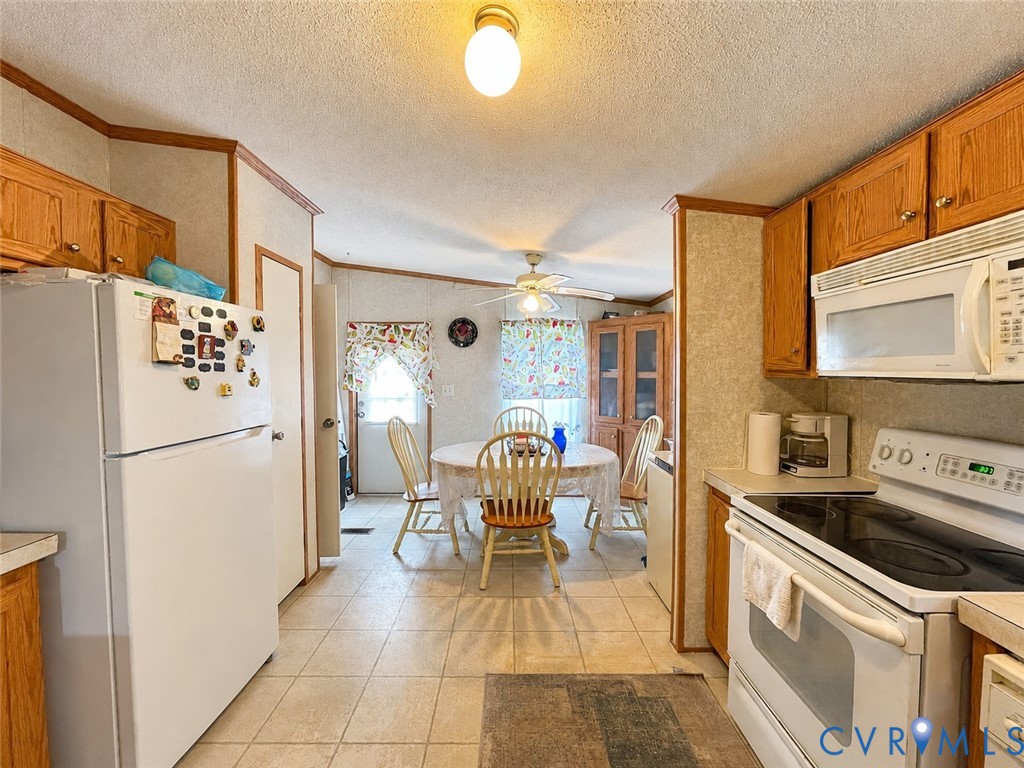 6873 Plank Road Kenbridge, VA 23944 - Photo 7 of 25 Functional kitchen with wood-finish cabinetry, til