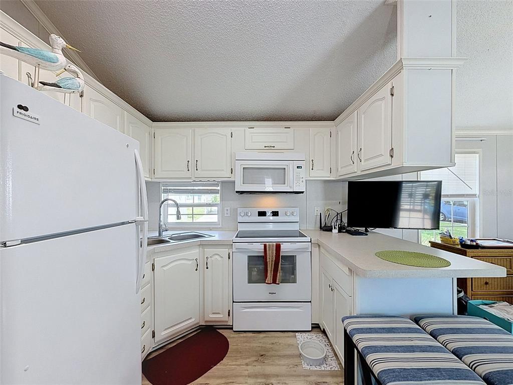 2092 Culbreath Road, Unit A42 Brooksville, FL 34602 - Photo 65 of 70 a kitchen with stainless steel appliances a refrigerator sink and white cabinets