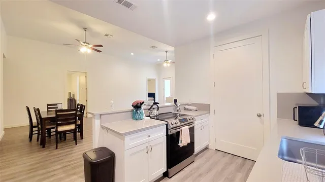 a view of a kitchen area with furniture and wooden floor