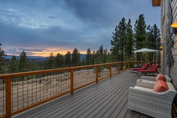 a view of a balcony with wooden floor and fence