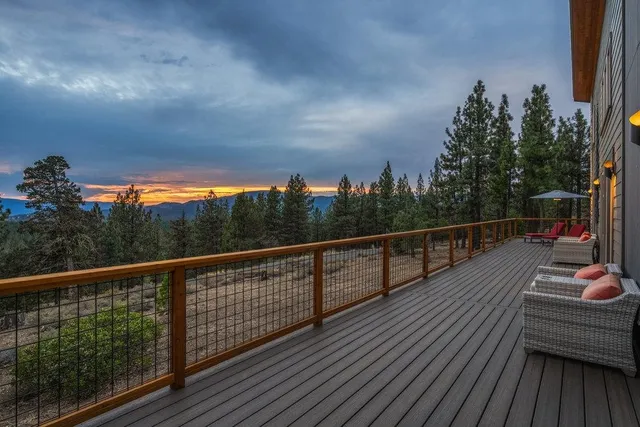 a view of a balcony with wooden floor and fence