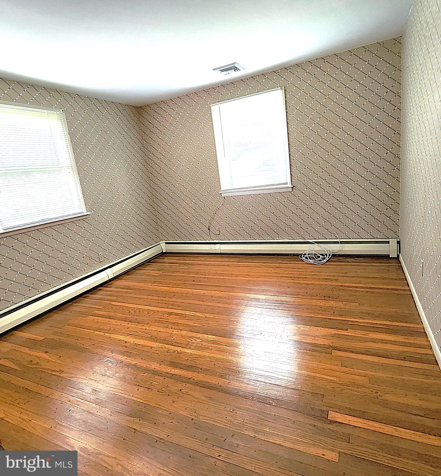 2613 Caranel Road Broomall, PA 19008 - Photo 25 of 49 an empty room with wooden floor and windows