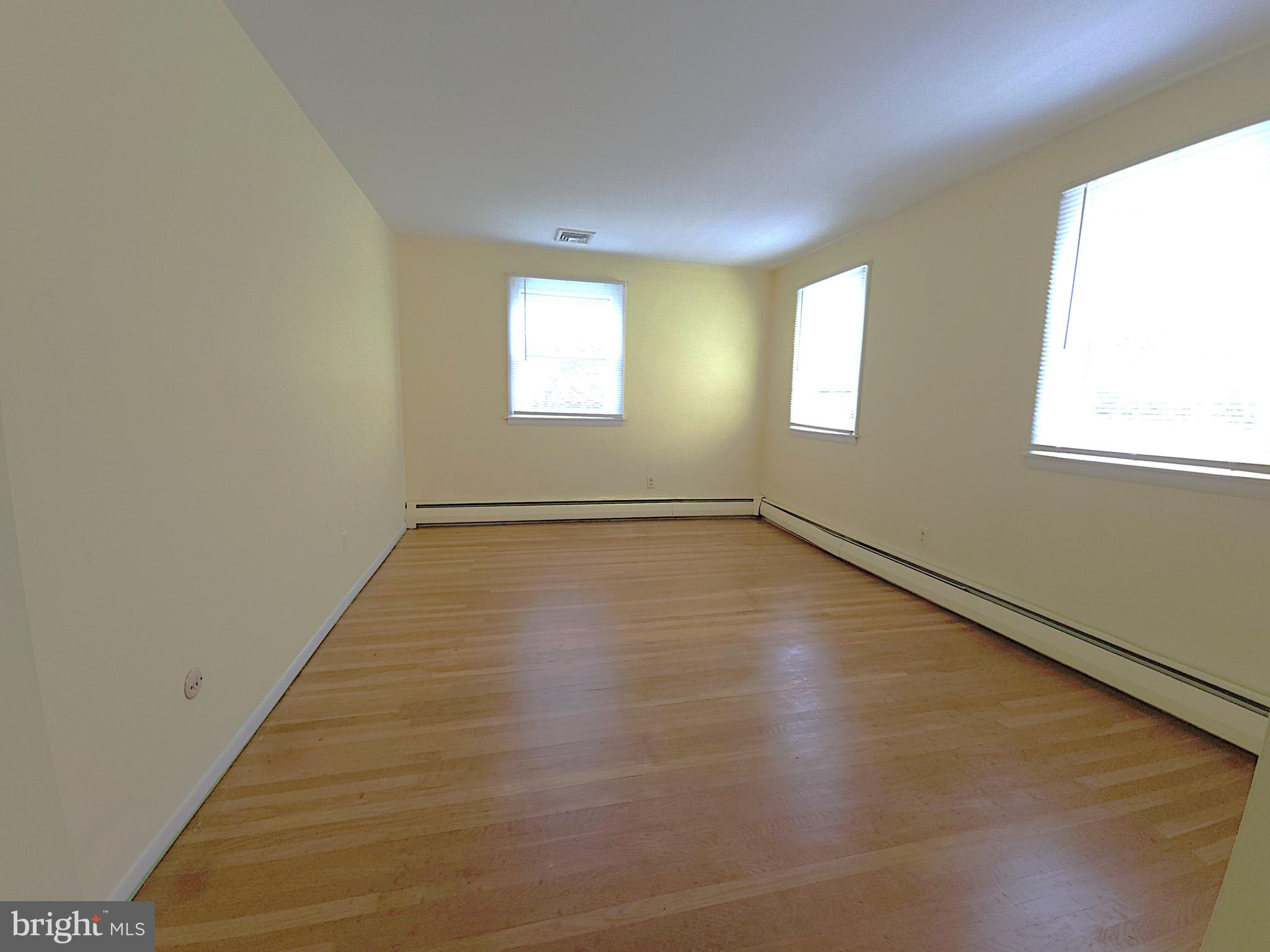 2613 Caranel Road Broomall, PA 19008 - Photo 27 of 49 an empty room with wooden floor and windows