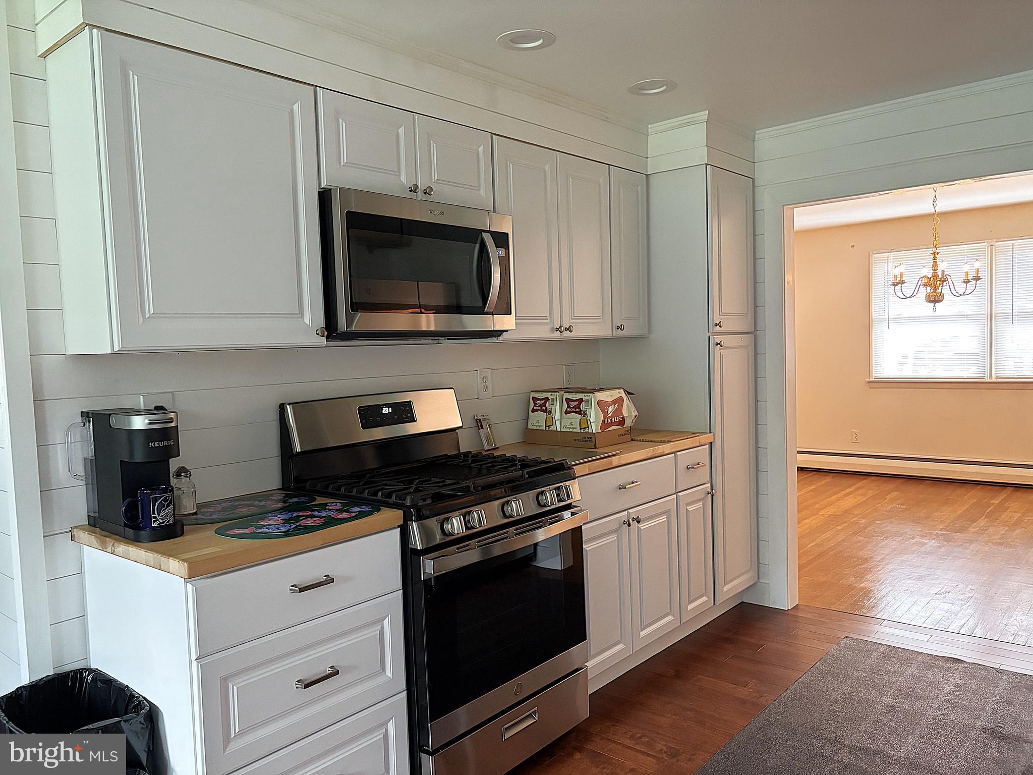 2613 Caranel Road Broomall, PA 19008 - Photo 9 of 49 a kitchen with granite countertop white cabinets and black appliances