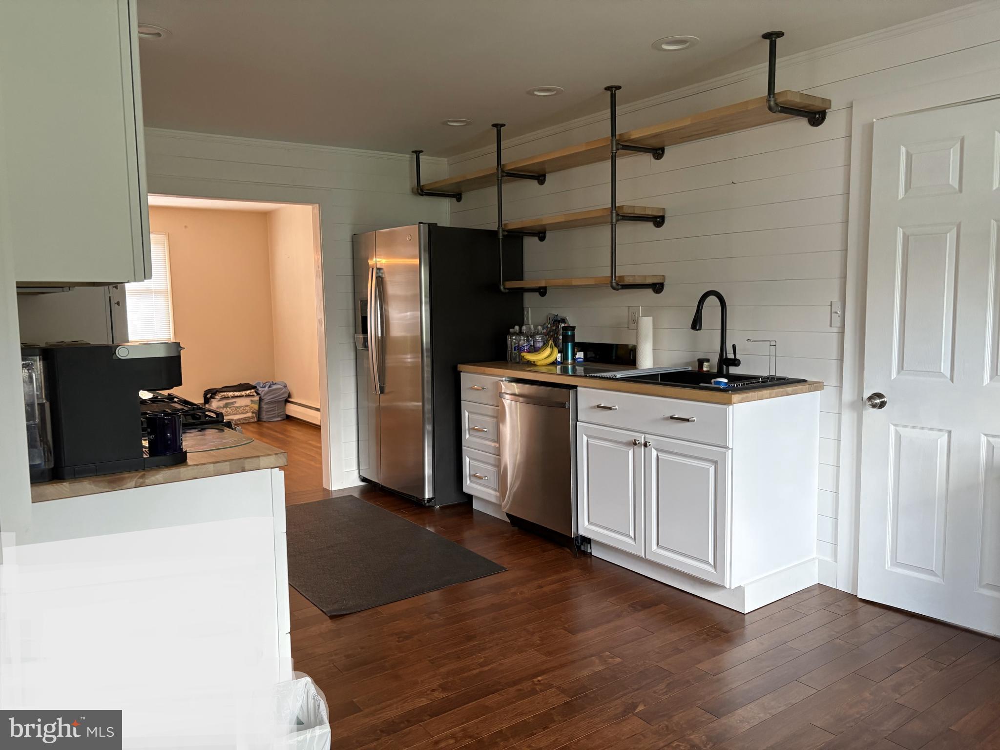 2613 Caranel Road Broomall, PA 19008 - Photo 10 of 49 a kitchen with stainless steel appliances a sink dishwasher a refrigerator a stove and white cabinets with wooden floor