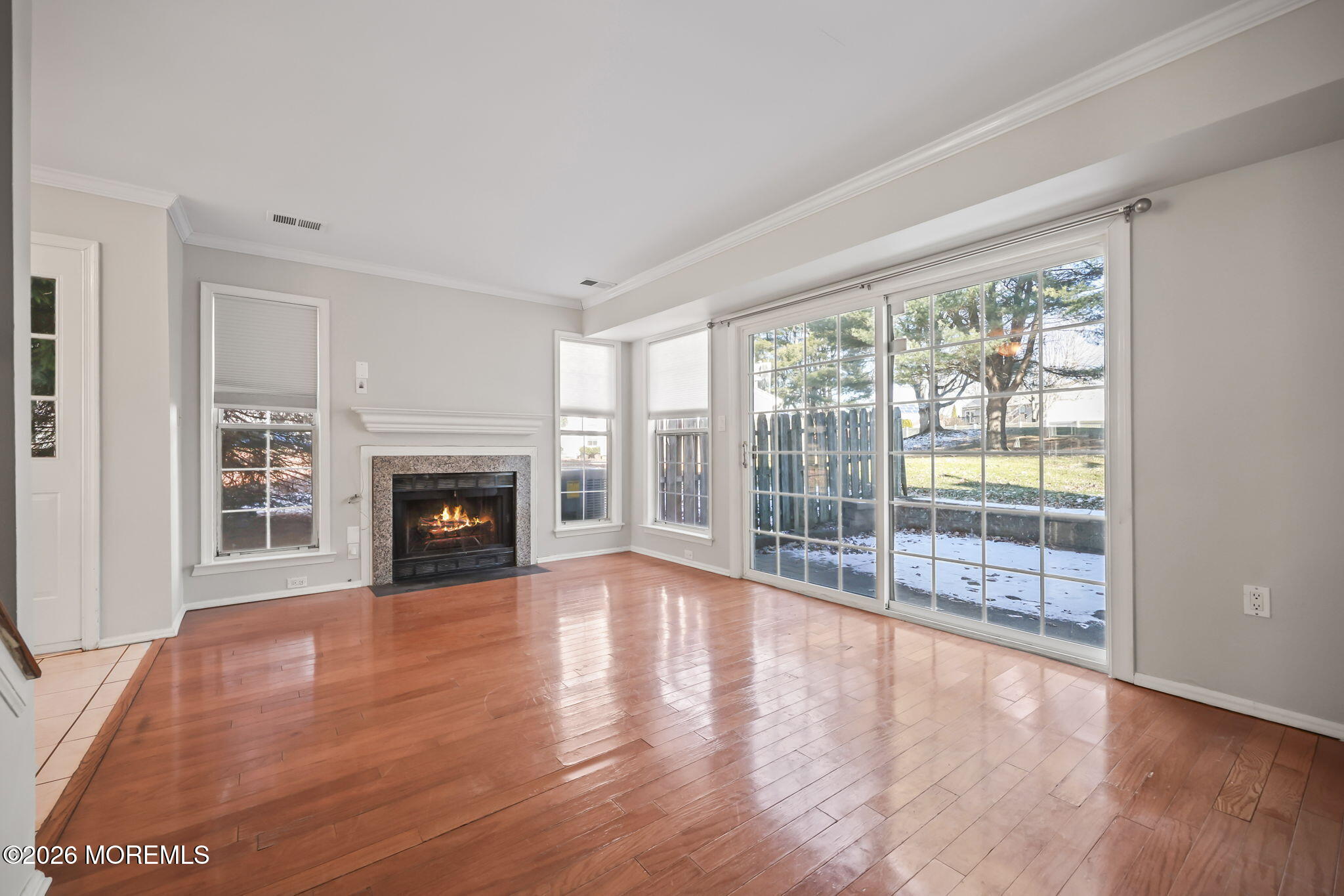 12 Duncan Way Freehold, NJ 07728 - Photo 13 of 30 a view of empty room with wooden floor and fireplace