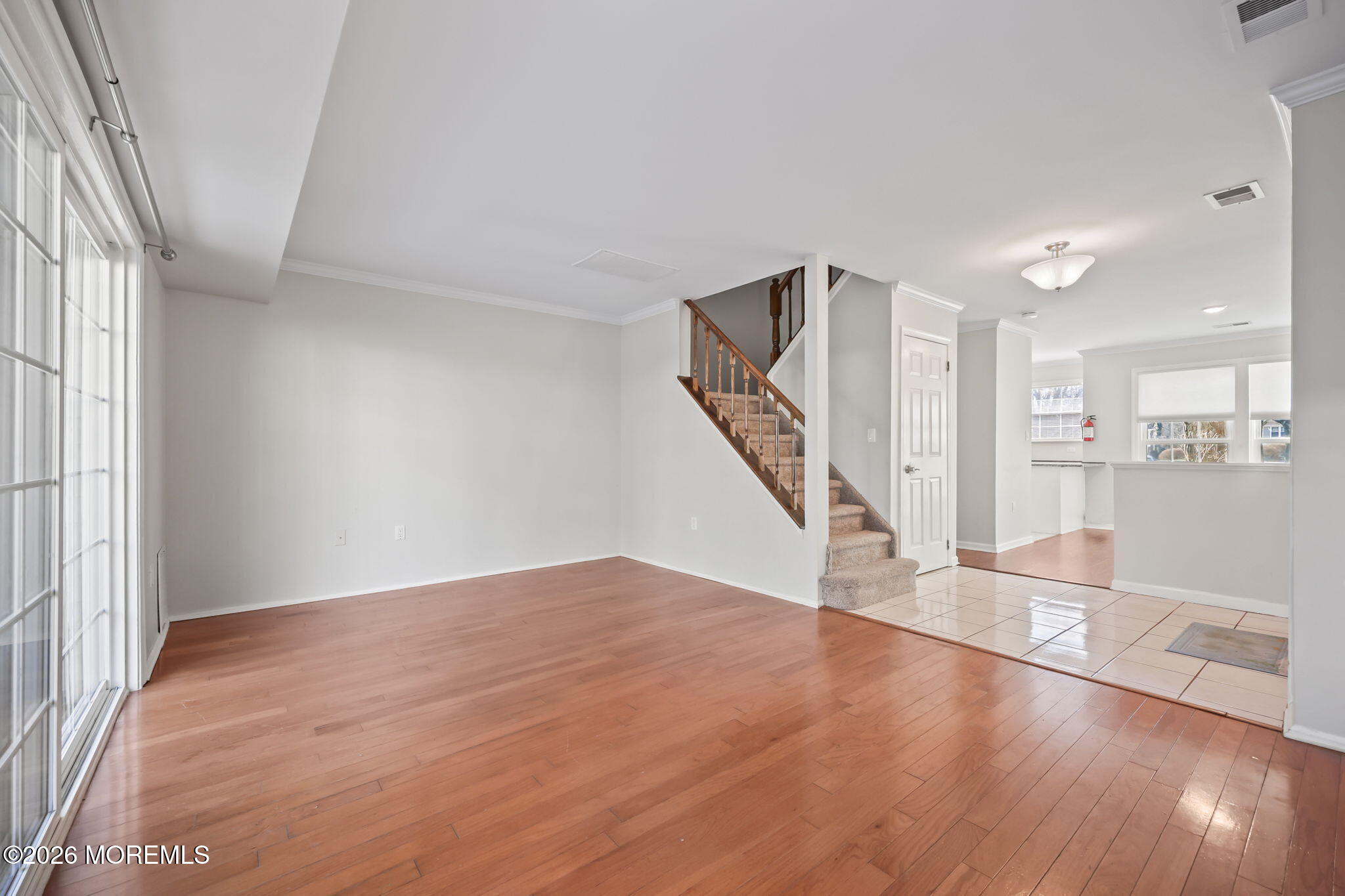 12 Duncan Way Freehold, NJ 07728 - Photo 14 of 30 wooden floor in an empty room with a window