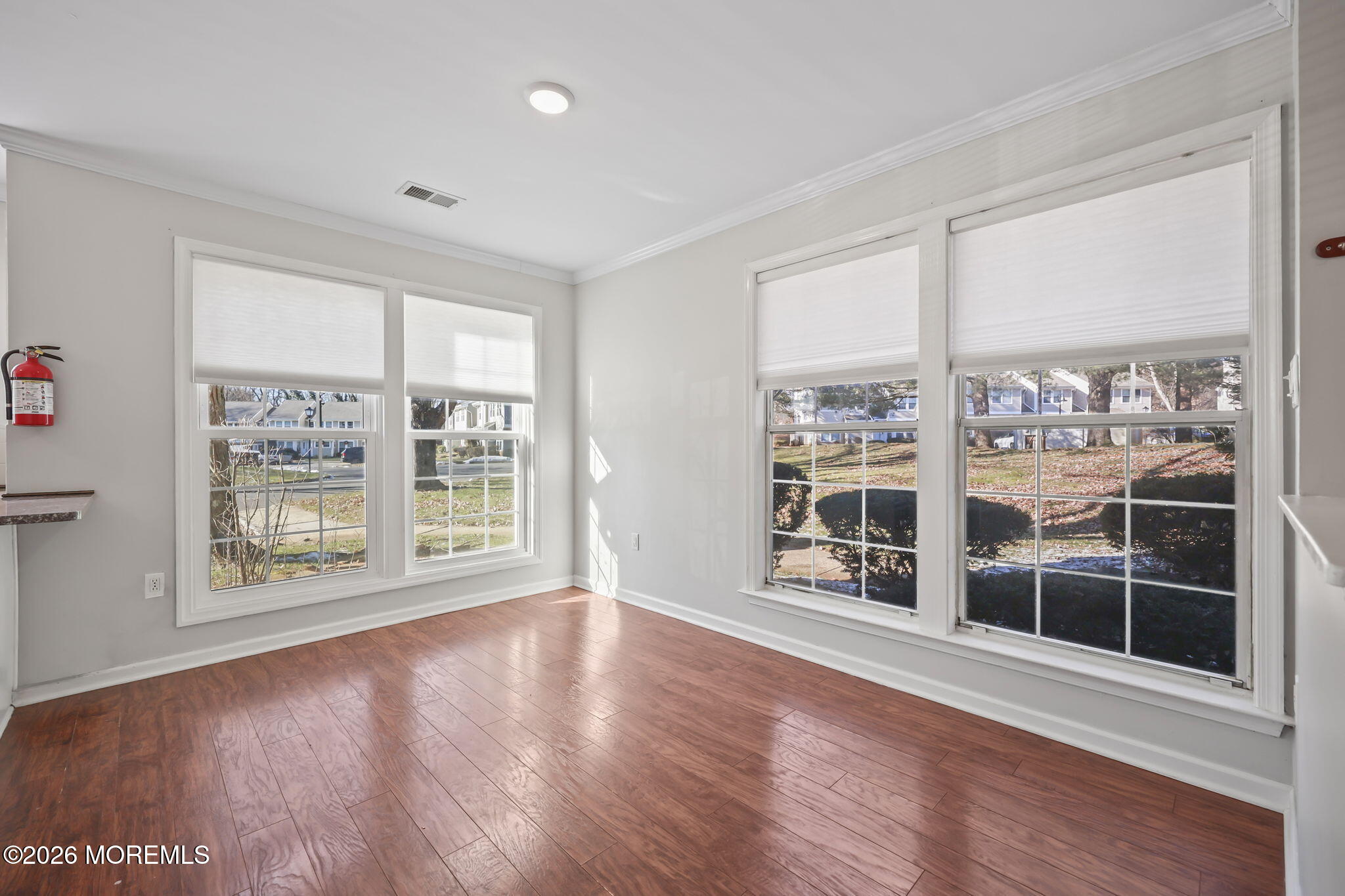 12 Duncan Way Freehold, NJ 07728 - Photo 5 of 30 a view of an empty room with wooden floor and a window