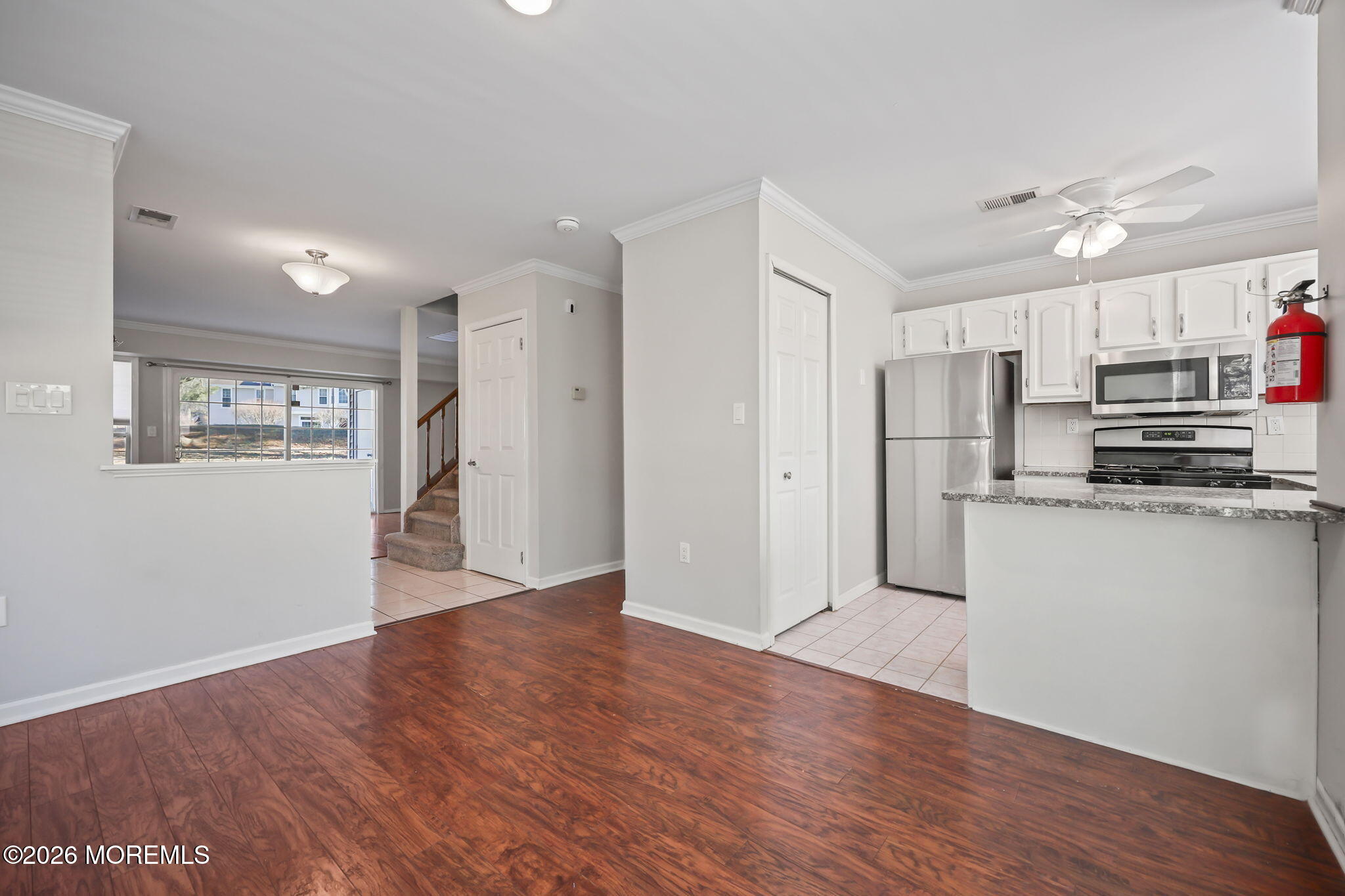 12 Duncan Way Freehold, NJ 07728 - Photo 6 of 30 a view of a kitchen with wooden floor and a refrigerator