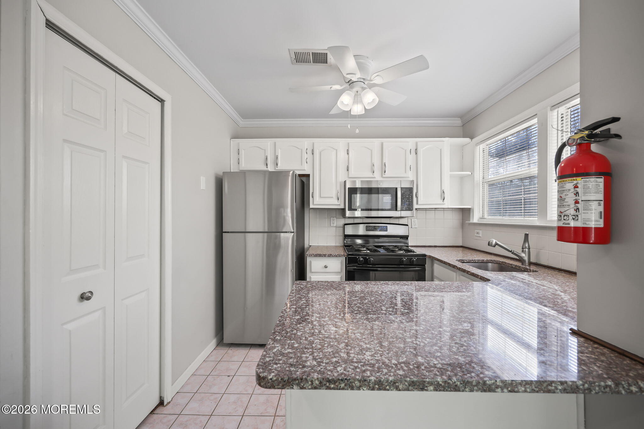 12 Duncan Way Freehold, NJ 07728 - Photo 7 of 30 a kitchen with granite countertop a refrigerator a sink a stove and cabinets