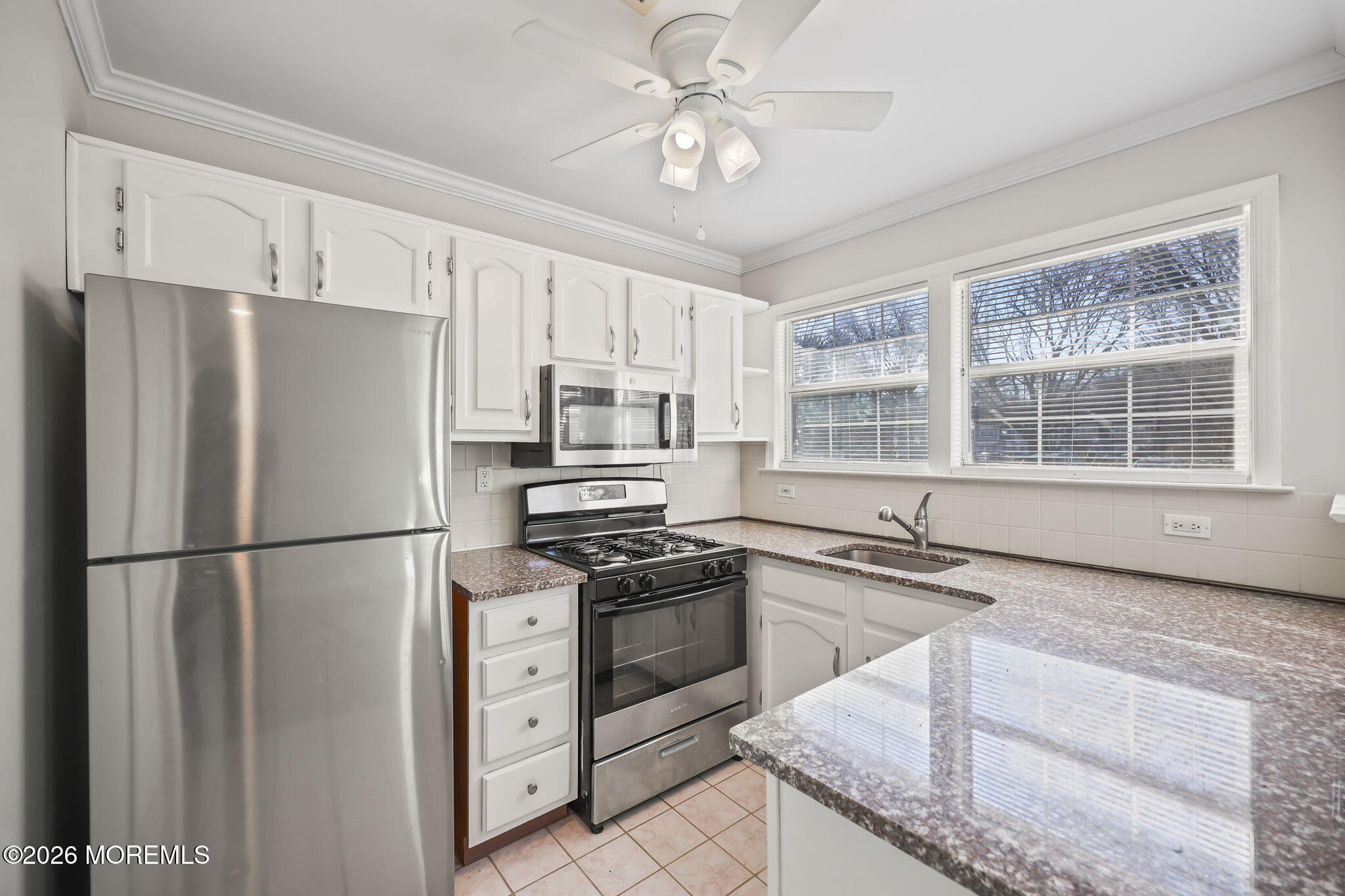 12 Duncan Way Freehold, NJ 07728 - Photo 8 of 30 a kitchen with white cabinets and stainless steel appliances