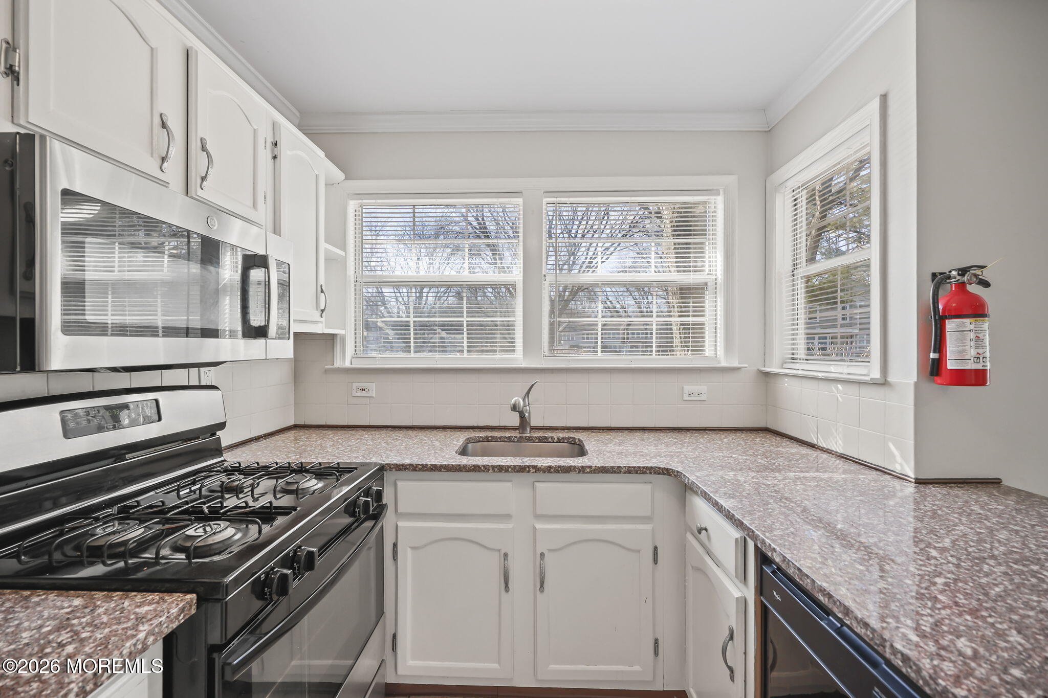 12 Duncan Way Freehold, NJ 07728 - Photo 9 of 30 a kitchen with granite countertop a sink stove and cabinets
