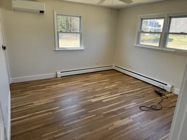 a view of a room with wooden floor and windows