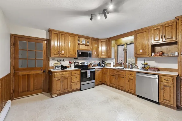 a kitchen with stainless steel appliances granite countertop a stove sink and cabinets