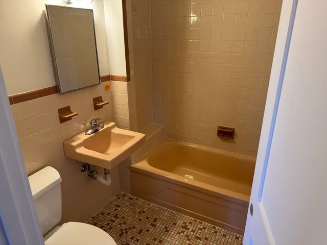 a bathroom with a sink a toilet and bathtub