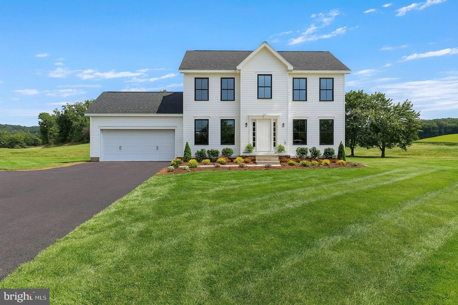 a front view of building with yard and green space