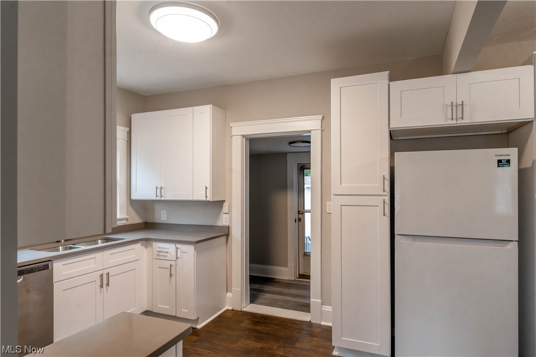 170 Avon Belden Road Avon Lake, OH 44012 - Photo 4 of 18 Kitchen featuring white refrigerator, sink, dark hardwood / wood-style floors, dishwasher, and white cabinetry
